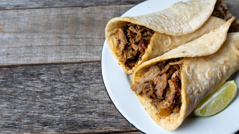 Traditional mexican tacos known as  "arabes" style on wooden background