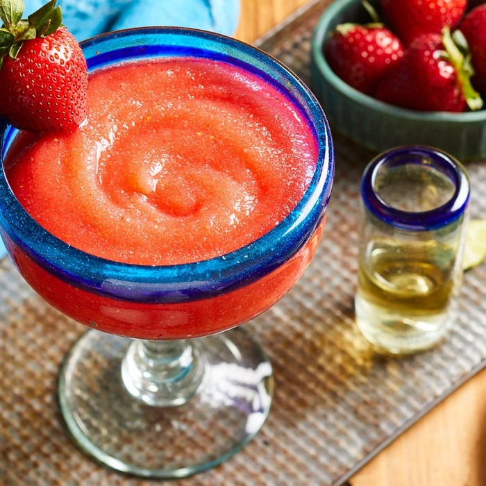 Frozen strawberry margarita and shot of teuila