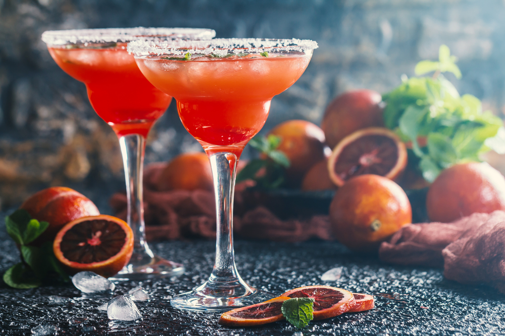 Chilling Blood Orange Margarita garnished with a crimson wheel, perfect for Halloween festivities.