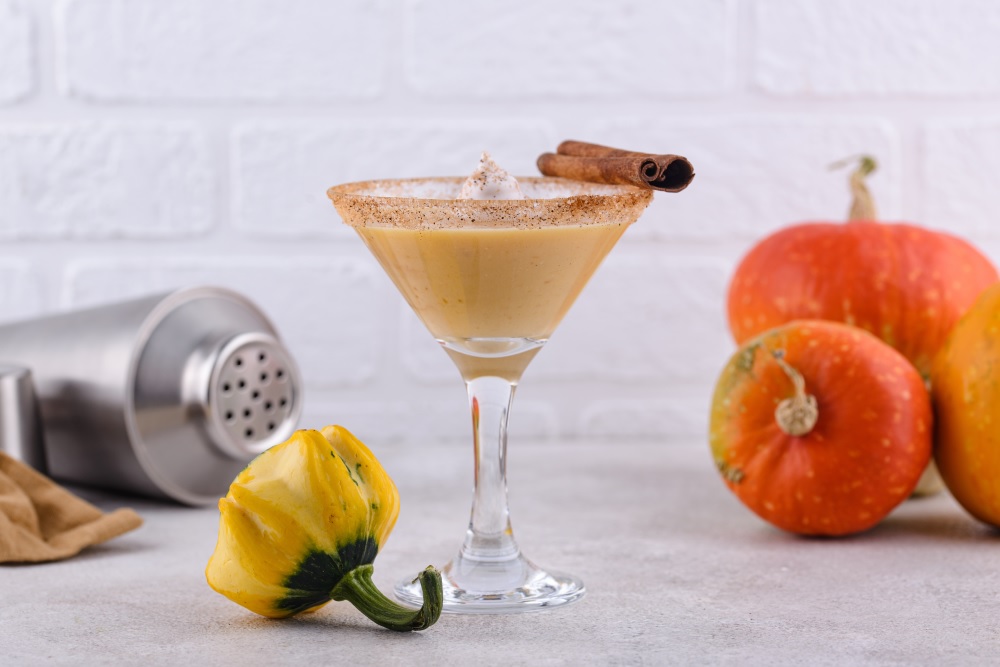 Ethereal Cinnamon-Horchata Martini with Licor 43, garnished with a cinnamon stick and a sugar-cinnamon rim, perfect for Halloween