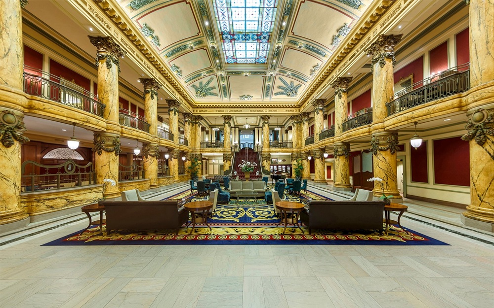 Jefferson Hotel's vintage exterior with its warm, welcoming front porch set in a serene backdrop.