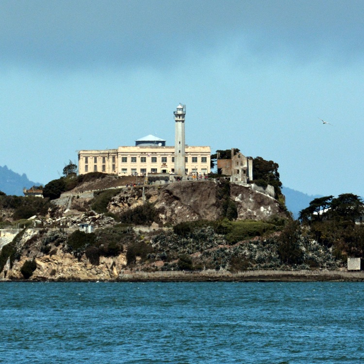 The ominous Alcatraz Island surrounded by the misty waters of San Francisco Bay.