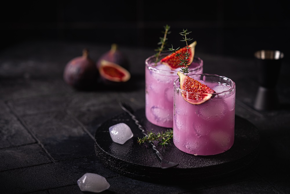 Purple,Fig,Cocktail,With,Ice,And,Thyme,On,Dark,Background