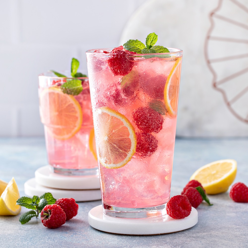 The Raspberry Lemonade and Tequila Refresher is a vibrant and tantalizing cocktail that's perfect for enjoying on those sunny spring afternoons. This delightful drink combines the tartness of raspberries and lemonade with the smooth kick of tequila, and is garnished with fresh lemon, mint, and berries for an extra splash of color and flavor. Ingredients: 1 ½ ounces of high-quality tequila 1 ounce of raspberry liqueur 3 ounces of freshly squeezed lemonade Fresh raspberries Fresh mint leaves Lemon slices Ice cubes Optional: soda water for a fizzy twist Garnish: Lemon wheel Fresh mint sprig Fresh raspberries Instructions: Prepare the Glass: Begin by chilling your preferred cocktail glass. This can be done by placing the glass in the freezer for a few minutes or by filling it with ice water and setting it aside as you prepare the cocktail. Muddle the Raspberries: In a shaker, gently muddle a handful of fresh raspberries. This releases their juice and essence, providing a deep, fruity base for your cocktail. Combine Ingredients: Add the tequila, raspberry liqueur, and lemonade to the shaker. If you're looking for a slightly less sweet drink, you can adjust the amount of raspberry liqueur to your liking. Shake it Up: Fill the shaker with ice and shake the mixture vigorously for about 15 seconds. Shaking not only chills the drink but also helps to blend the flavors seamlessly. Strain and Serve: Strain the mixture into your prepared glass, ensuring that the ice and raspberry seeds are left behind. Add Fizz (Optional): For those who enjoy a bit of fizz, top the drink off with a splash of soda water. Garnish: Garnish your cocktail with a lemon wheel, a sprig of fresh mint, and a few fresh raspberries. The garnish adds a touch of elegance and an extra burst of flavor and aroma. The combination of sweet raspberries, tangy lemonade, and smooth tequila, garnished with fresh lemon, mint, and berries, creates a symphony of flavors that's sure to delight. Whether you're hosting a springtime gathering or simply enjoying a quiet moment alone, this cocktail is the perfect way to welcome the season of renewal and growth. Cheers to spring!