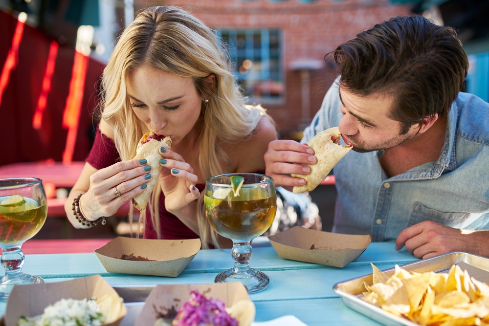 Romantic,Couple,Eating,Street,Tacos,At,Outdoor,Mexican,Restaurant