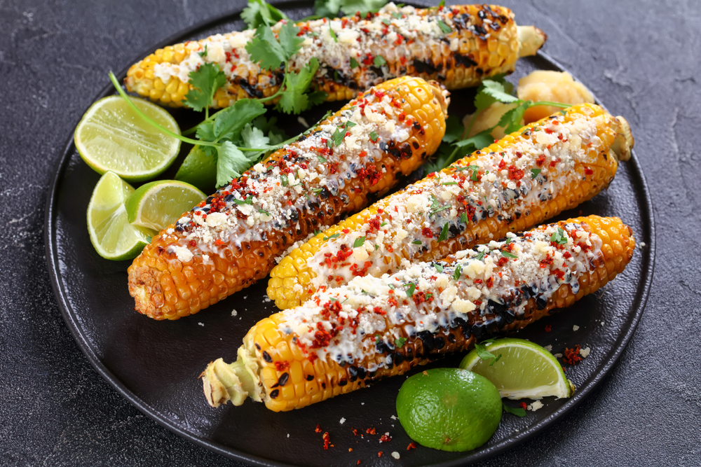 Elote,,Grilled,Mexican,Street,Corn,,Charred,Cobs,Are,Slathered,In