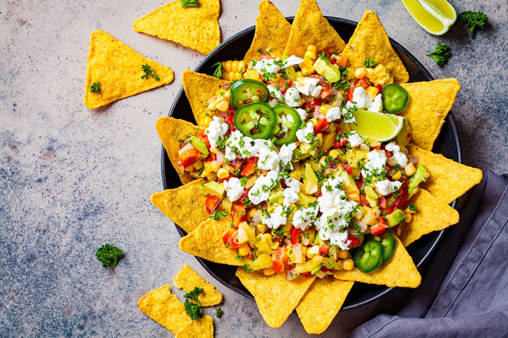 Mexican,Street,Corn,Salad,With,Cheese,And,Nachos,Chips,In